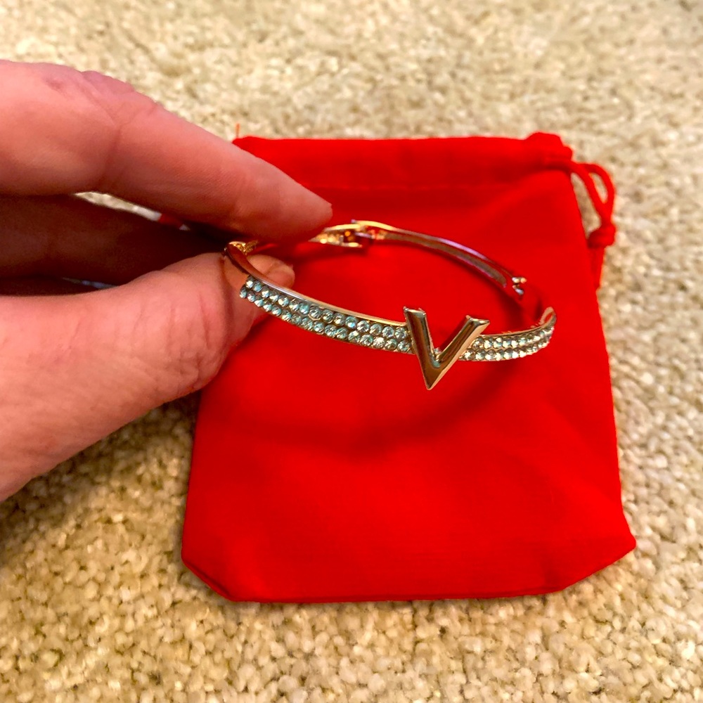 Gold tone cuff bracelet with CZ and emblem NWOT